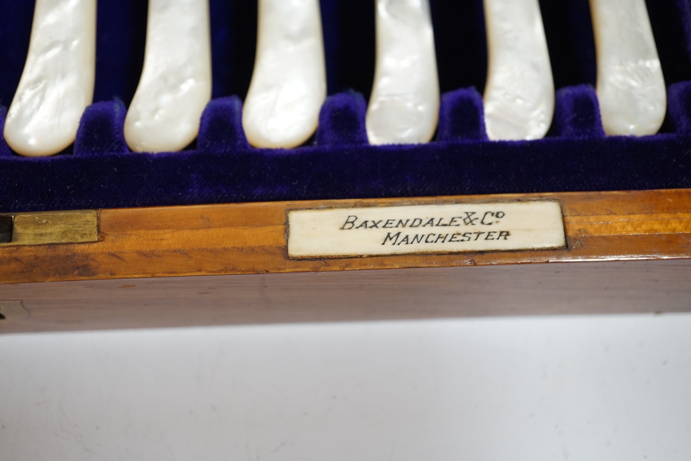 A cased set of twelve pairs of Edwardian silver and mother of pearl pistol handled dessert eaters, Josiah Williams & Co, London, 1908, knife 17.6cm.